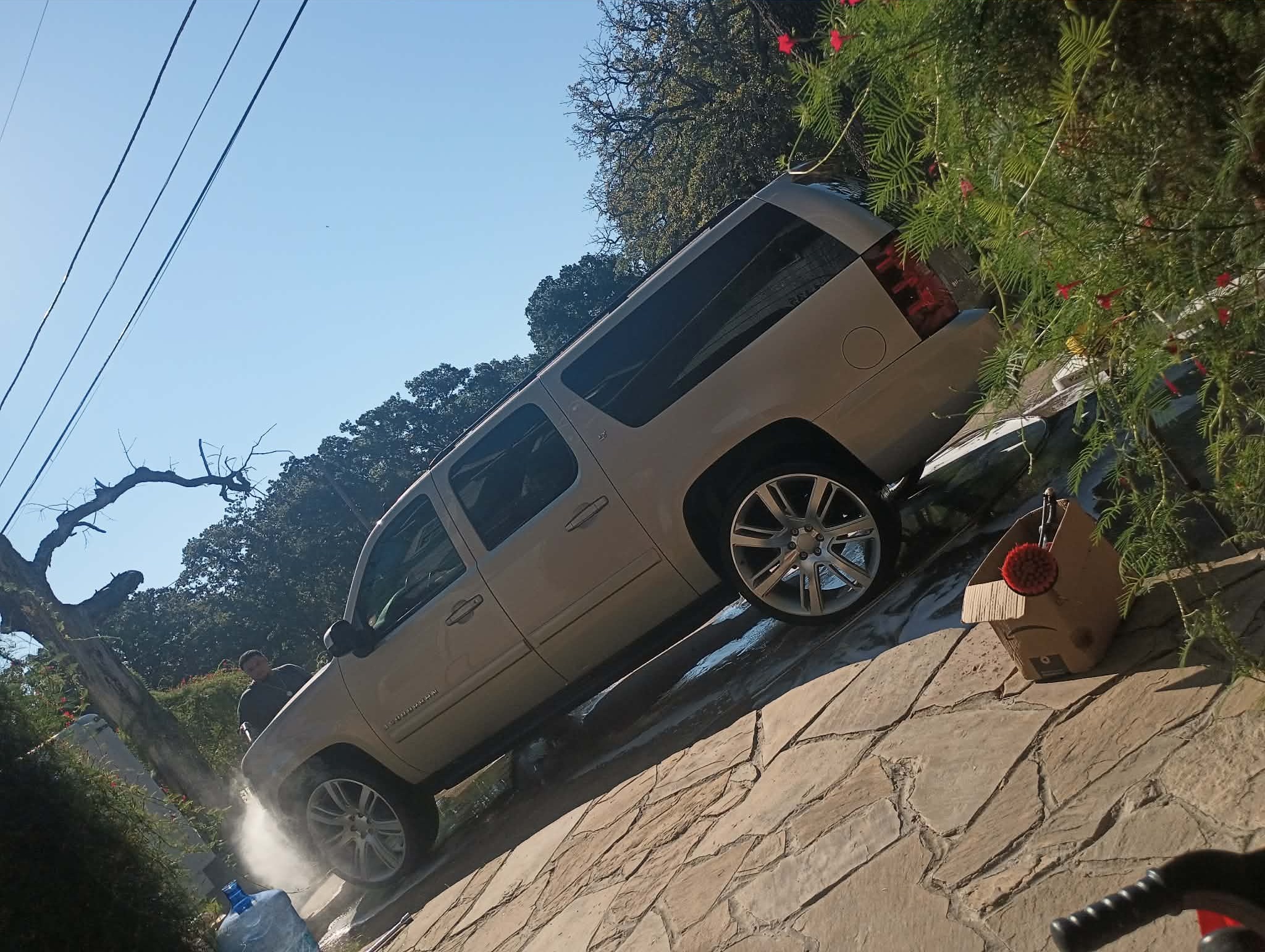 Rinsing a Chevrolet Suburban after the wash